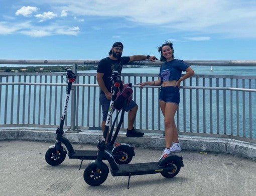 Enjoying a seaside ride on e-scooters with friends