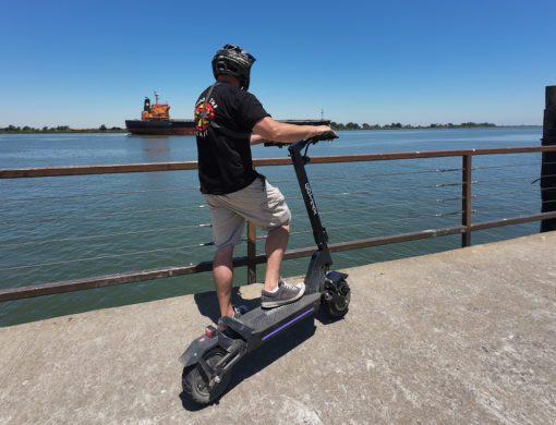 Riding an e-scooter by the seaside, perfect for coastal journeys