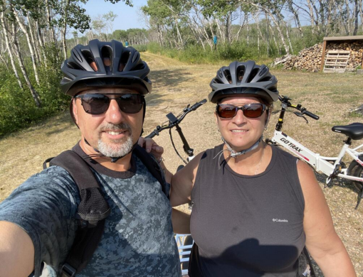 Couple riding e-bikes together outdoors for shared adventures