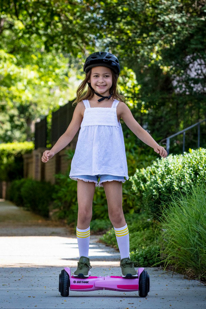 Young girl is enjoying safe and fun hoverboard riding in the park